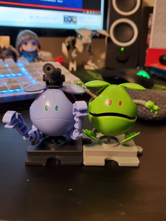 Photo of two Haro model kits: one is lavender and resembles the Gundam 'Ball', and the other is a classic green Haro.